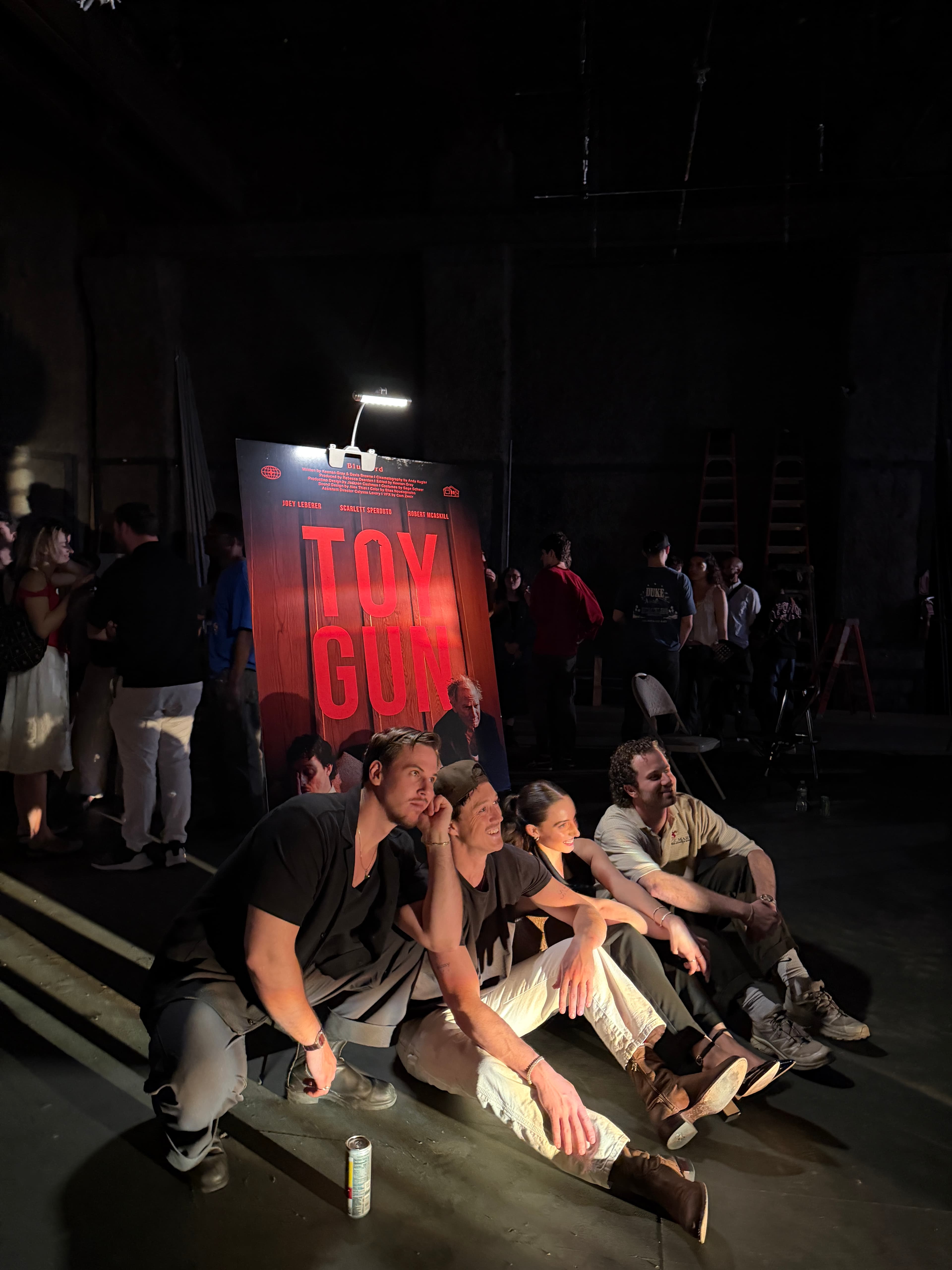 Filmshow team gathered near a Toy Gun poster